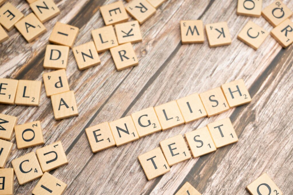 pexels-photo-19902304-19902304 Wooden Scrabble tiles spelling out 'English Test' on a wooden background, ideal for language exam themes.